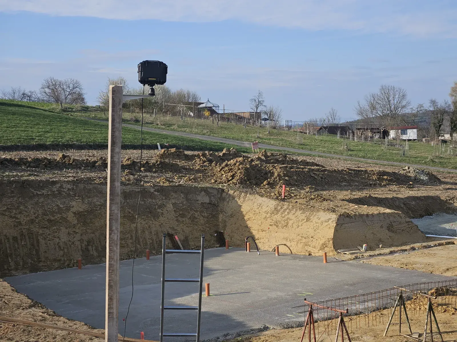 Camera on a post overlooking an excavation and foundation slab